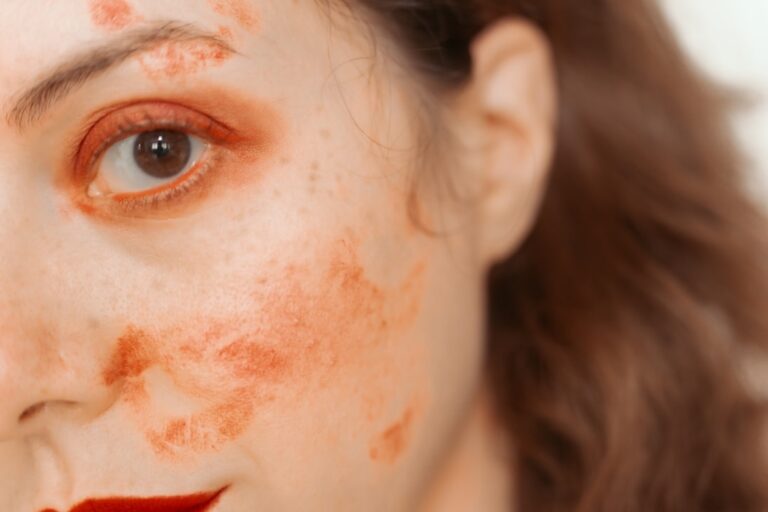 Woman with red paint smudges on face