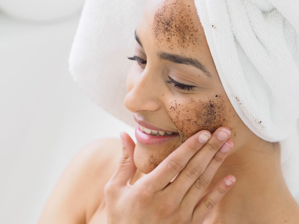 Woman enjoying skincare routine with coffee scrub exfoliation for healthy skin.