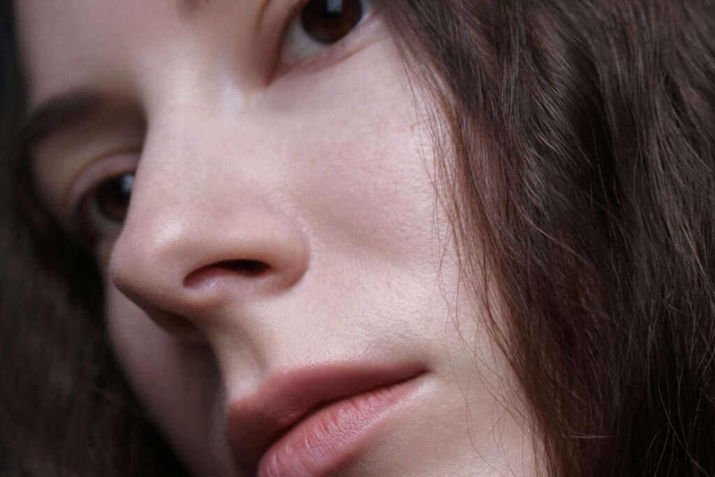 Detailed close-up portrait featuring the natural beauty of a woman's face and hair.
