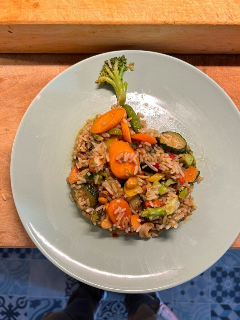 a white plate topped with rice and veggies